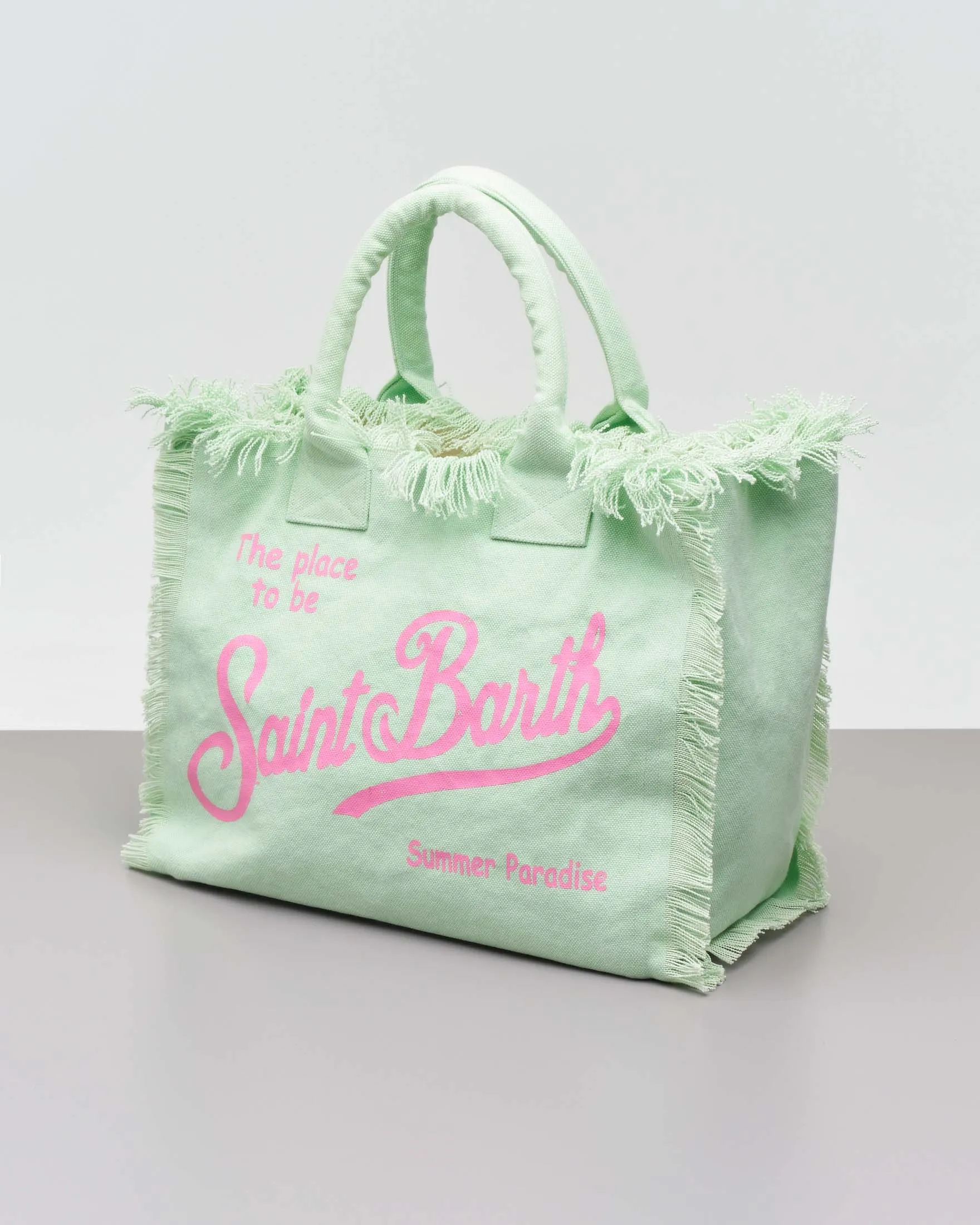 Borsa in canvas di cotone verde menta con scritta logo fucsia stampata e frange lungo i profili